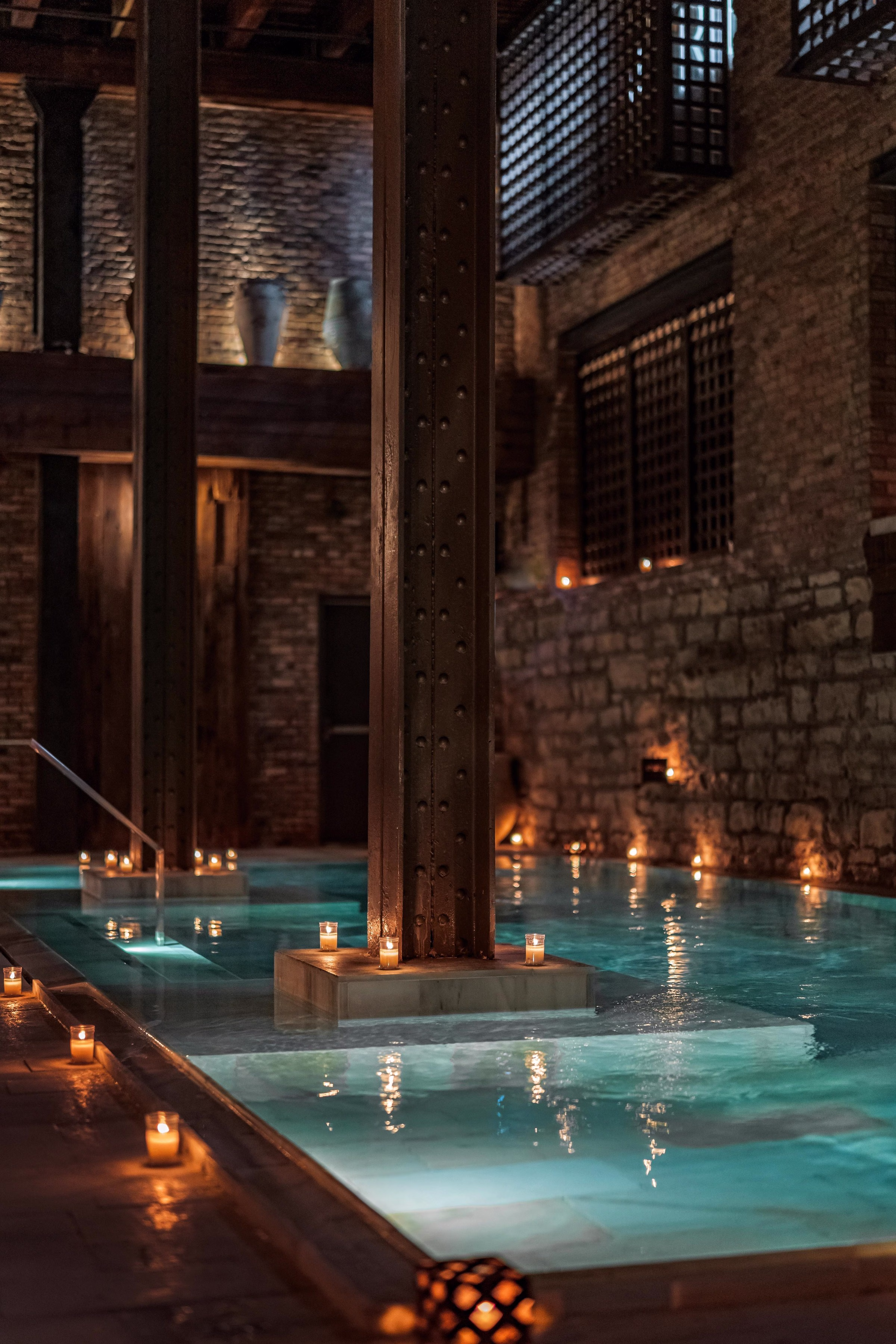 AIRE Ancient Baths saltwater floatarium with industrial steel columns and candlelight in New York