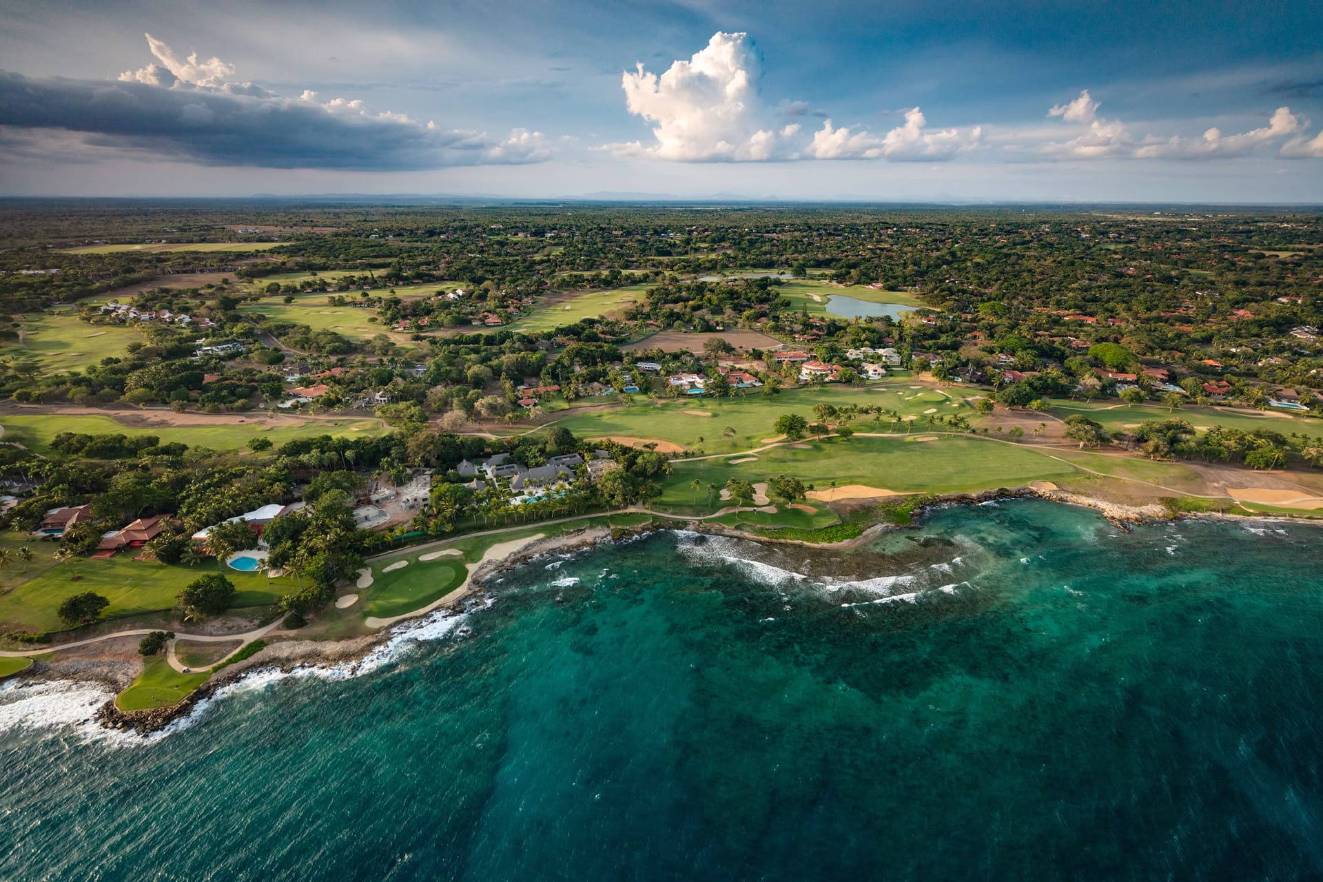 Casa de Campo La Romana shoreline drone aerial showing the resort coast, palm groves, and turquoise waters