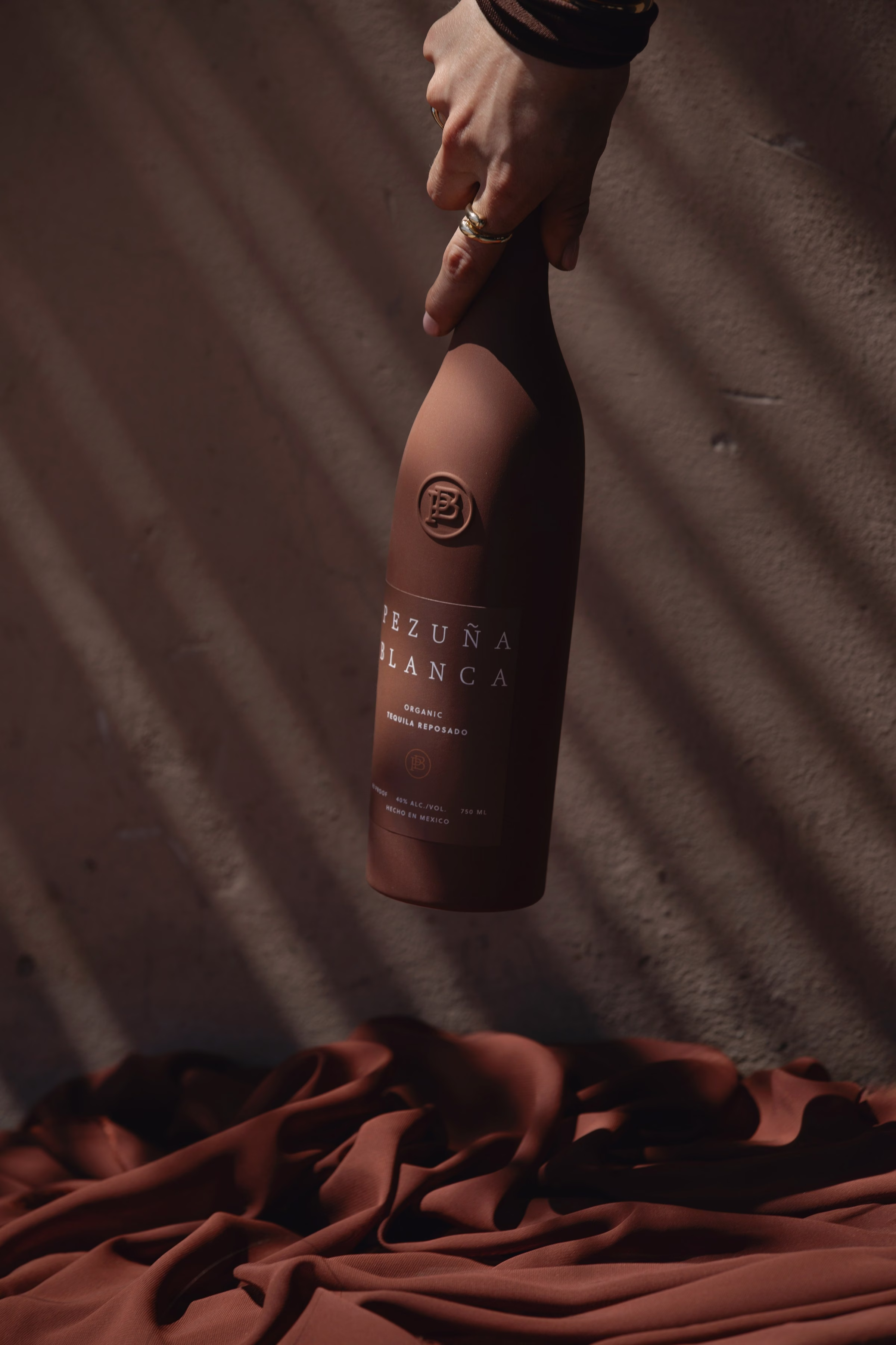 Pezuna Blanca premium tequila bottle in editorial lifestyle styling
