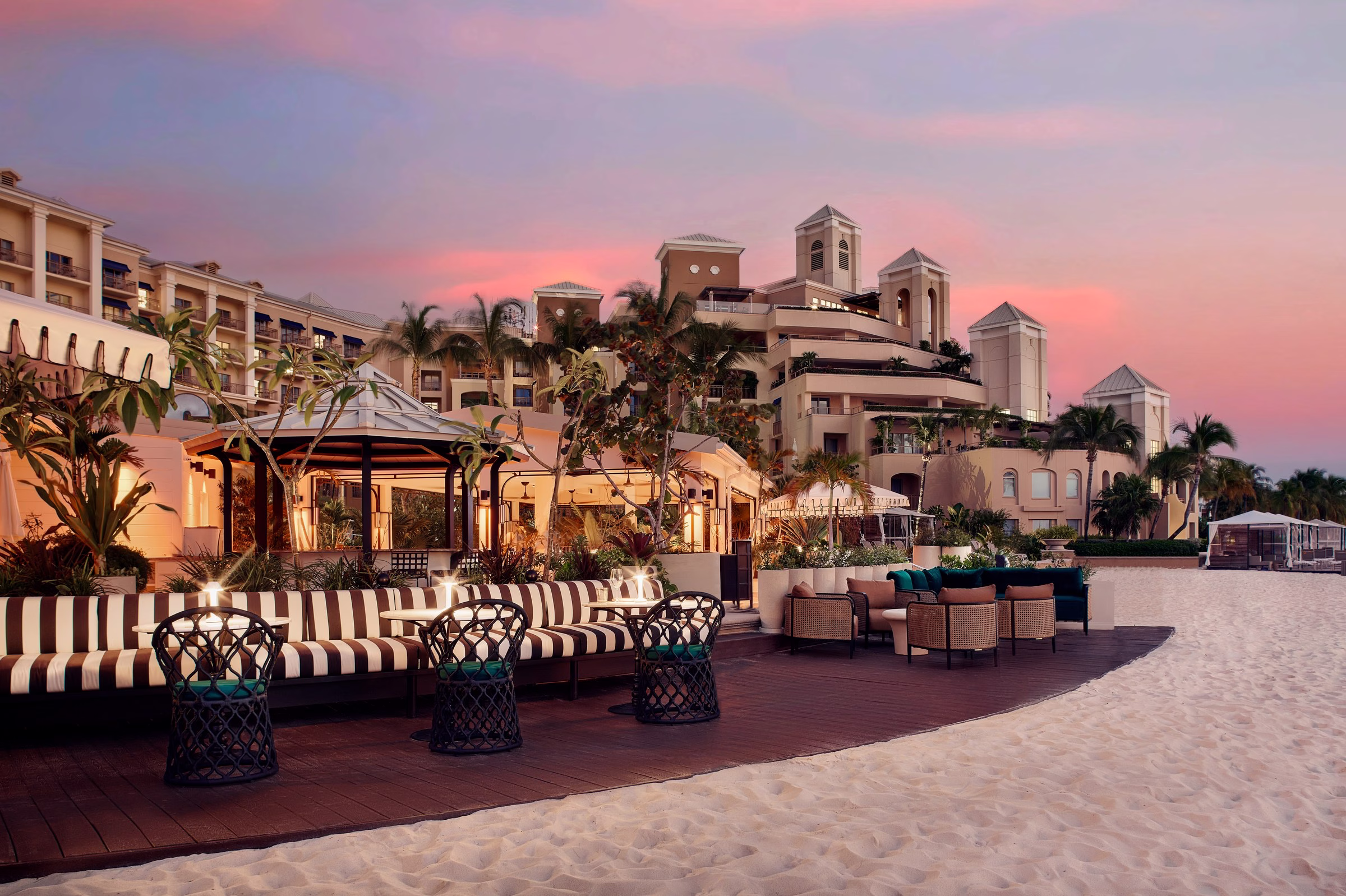 The Ritz-Carlton Grand Cayman Saint June restaurant terrace at sunset overlooking the Caribbean