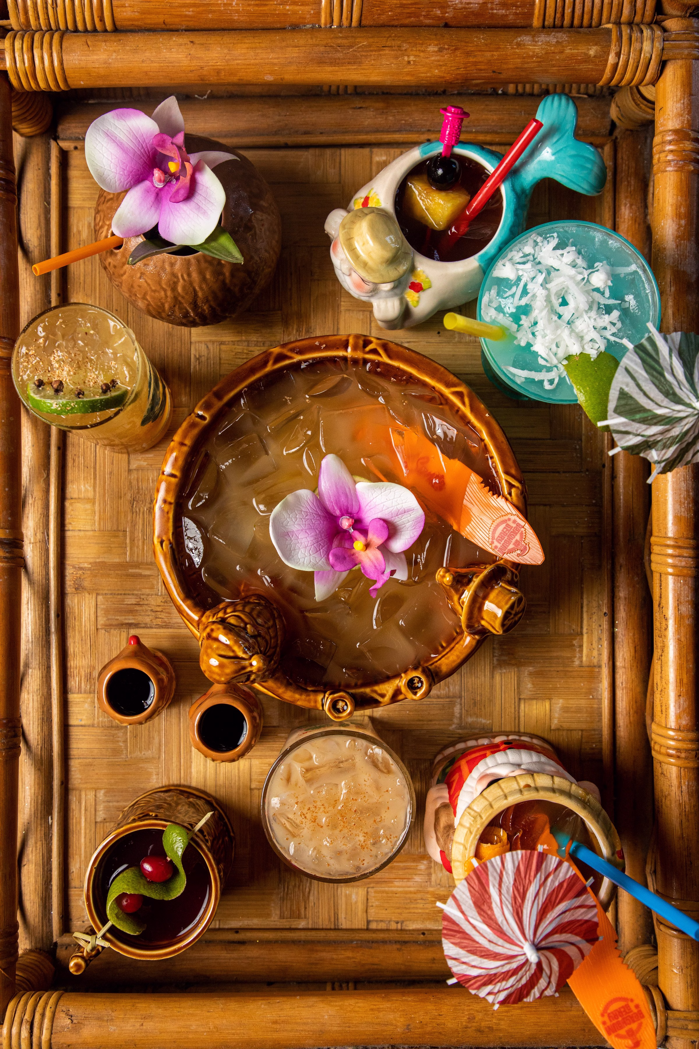 Sippin' Santa tiki cocktail spread photographed overhead with Beachbum Berry's signature tropical holiday drinks