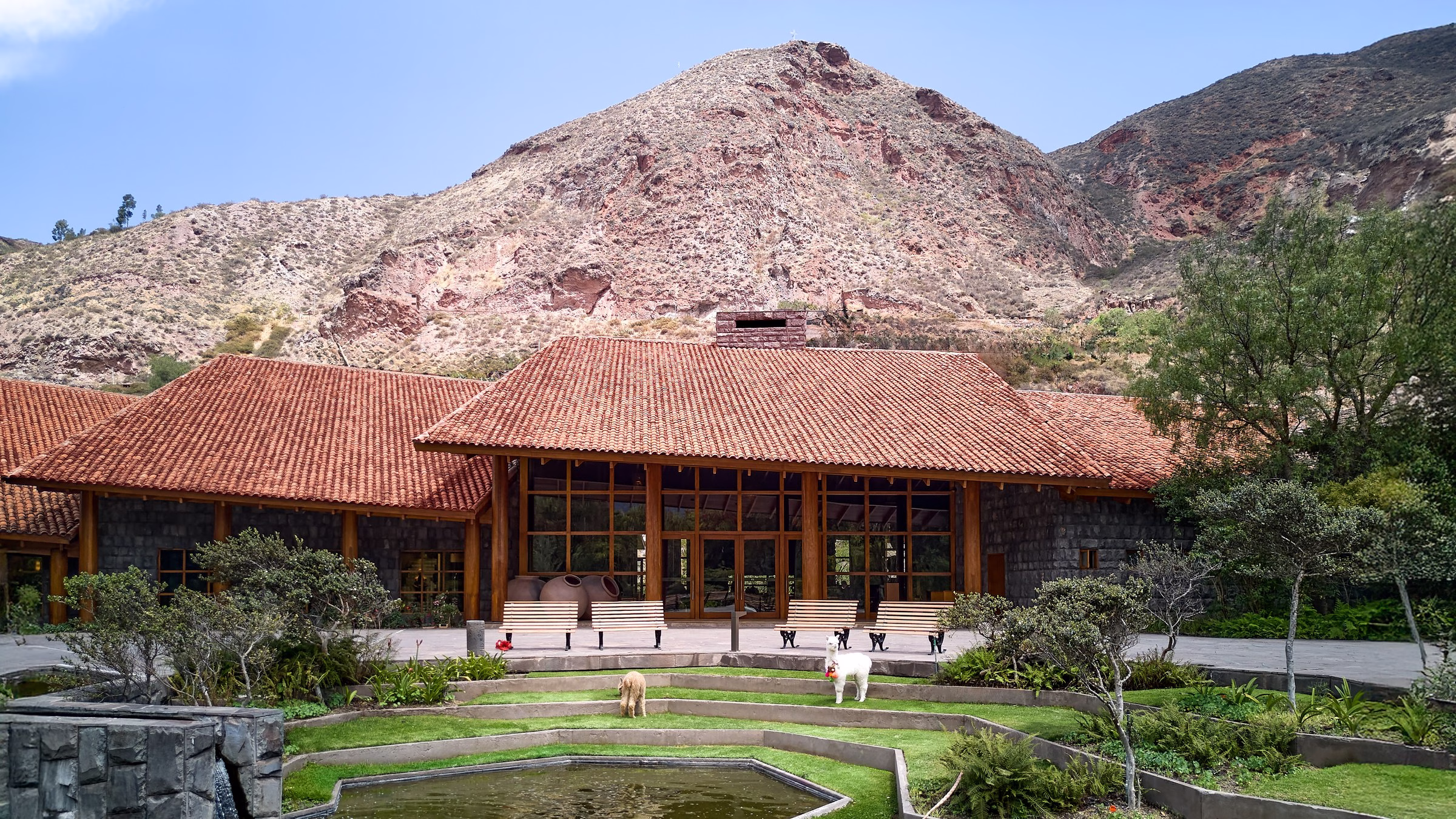 Tambo del Inka Sacred Valley resort facade with stone walls and Andean mountain backdrop